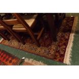 Persian style richly coloured wool rug, geometric patterns throughout, 68ins x 45ins