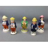 Five 19th century Staffordshire pepperettes to include a policeman, three with cobalt blue jackets