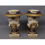 Pair of Wedgwood copana style urns (lacking lids) with gilded and garland decoration, blue ground (