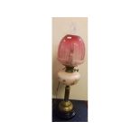 Victorian brass oil lamp, black glass circular stand, fluted brass column, opaque floral font,