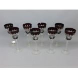 Set of eight ruby flash cut wine glasses with clear stems and circular bases, chips throughout, 8ins