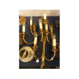 Set of four modern brass wall lights with two sconces with cast detail and ribbon tops, each 16ins