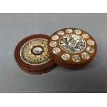 Modern Oriental hardwood circular compass with hinged lid and etched bone panels, decorative scenes,