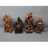 Four Chinese root carved figures to include an old sage fisherman, a warrior with lion at foot, a