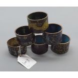 Six assorted brass and cloisonn floral decorated napkin rings