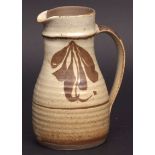 Studio pottery jug possibly by David Leach with abstract designs on a speckled ground