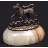 Early 19th century and later serving dish handle paperweight modelled as a dog with one raised paw