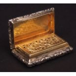 George IV vinaigrette of waisted rectangular form with hinged cover and foliate borders with