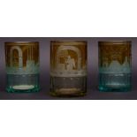 Collection of three lemon-tinted Bohemian glass beakers of cylindrical form, each etched with