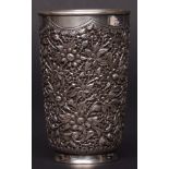 Chinese silver coloured metal small beaker, heavily cast with a dense flower and bamboo design,