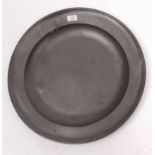 Large 18th century pewter charger of plain circular dished form, stamped with five sets of initials;
