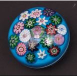 Clichy blue ground paper weight of domed circular form and set with a multi-coloured rosette