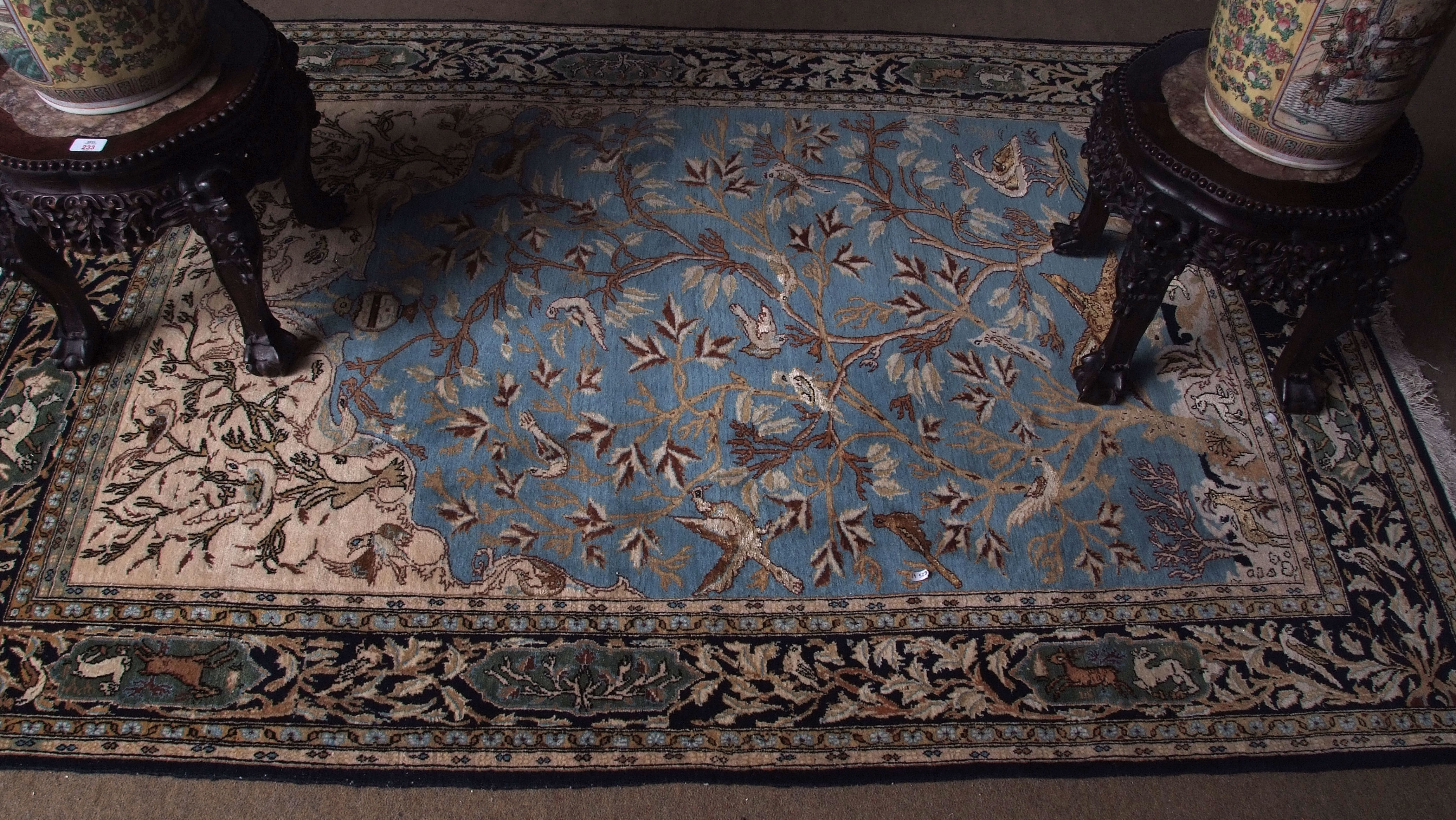 Good quality Iranian silk carpet, decorated throughout with birds and animals amongst trees to a