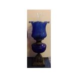 Victorian cast iron base oil lamp with blue font and matching crimped edge shade, 22ins high