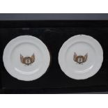 Pair of ebonised framed English plates with printed armorial style centres, "Verversching