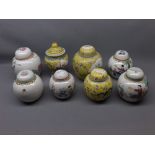 Group of eight Oriental ginger jars with decorative scenes, to include three yellow glazed ginger