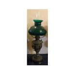 Metal cherub embossed and gilded oil lamp on a turned ebonised base, green shade, 22ins high