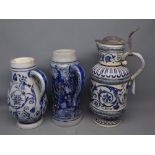 Three stoneware ewers with blue raised relief, one with pewter lid and one decorated with animals,