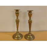 Pair of antique brass candlesticks on circular bases, 12ins tall (a/f)