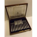 Mahogany cased set of six silver plated dessert knives and forks retailed by Carrington Co Ltd