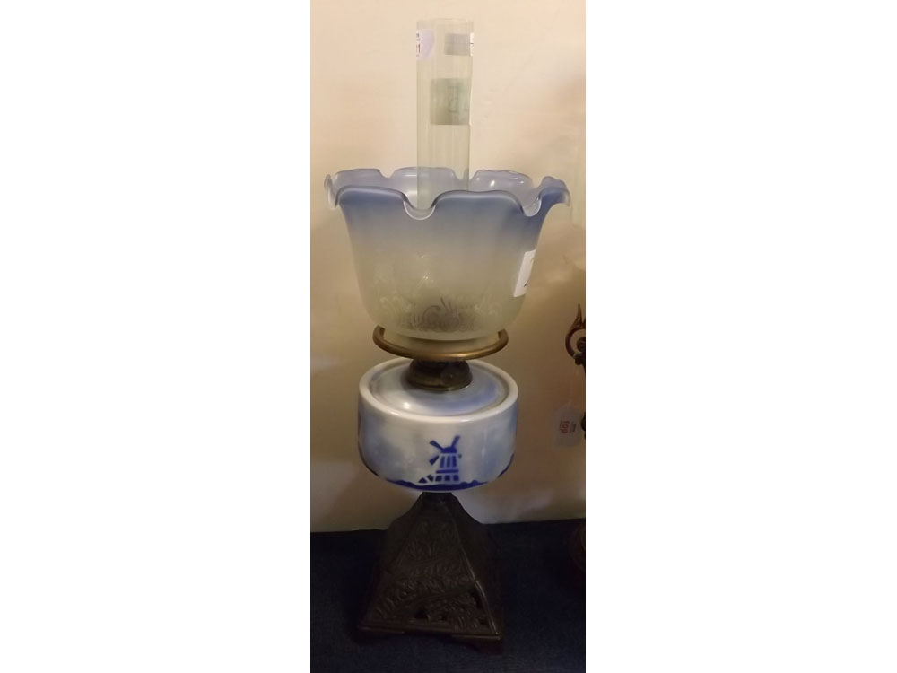 Victorian cast iron based oil lamp with blue and white glass windmill decorated font, etched blue