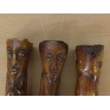 Collection of three primitive type na ve carved horn figures, the largest 7ins high