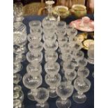 Thirty-three piece glass suite comprising champagne glasses, wine glasses with half fluted bowl