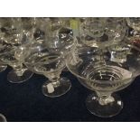 Group of assorted drinking glasses to include three green stemmed Hock glasses, mixed sundae dishes,