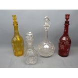 Bohemian red glass ivy leaf etched decanter together with a further matching amber decanter and