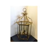 Reproduction brass ceiling lantern with six glass panels and three candle sconces, scrolling
