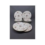 Set of four Coalport plates, floral decorated, retailed by Maple & Co of London, with gilded rim,