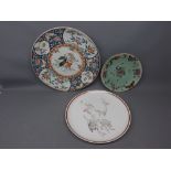 Japanese collectors plate with a frolicking animals design, together with a Chinese green glazed