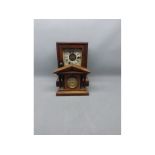 Miniature mahogany framed mantel clock, flanked by four reeded columns with brass dial, together