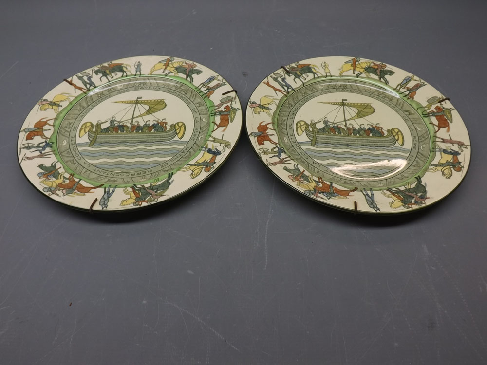 Pair of Doulton Series ware plates with a Roman ship design to centre, knights on horseback with