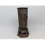 Late 20th century hexagonal bronzed form vase with raised relief and ringlet handles supported on