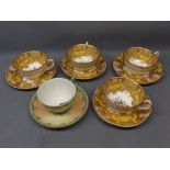 Set of four Royal Worcester cups and saucers with yellow and gilded border, central floral design (