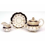 Large mid-19th century Rockingham style porcelain teapot of rococo shape with matching stand and