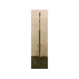 Art Nouveau stylised brass adjustable lamp stand on three spade style feet, with twisted brass