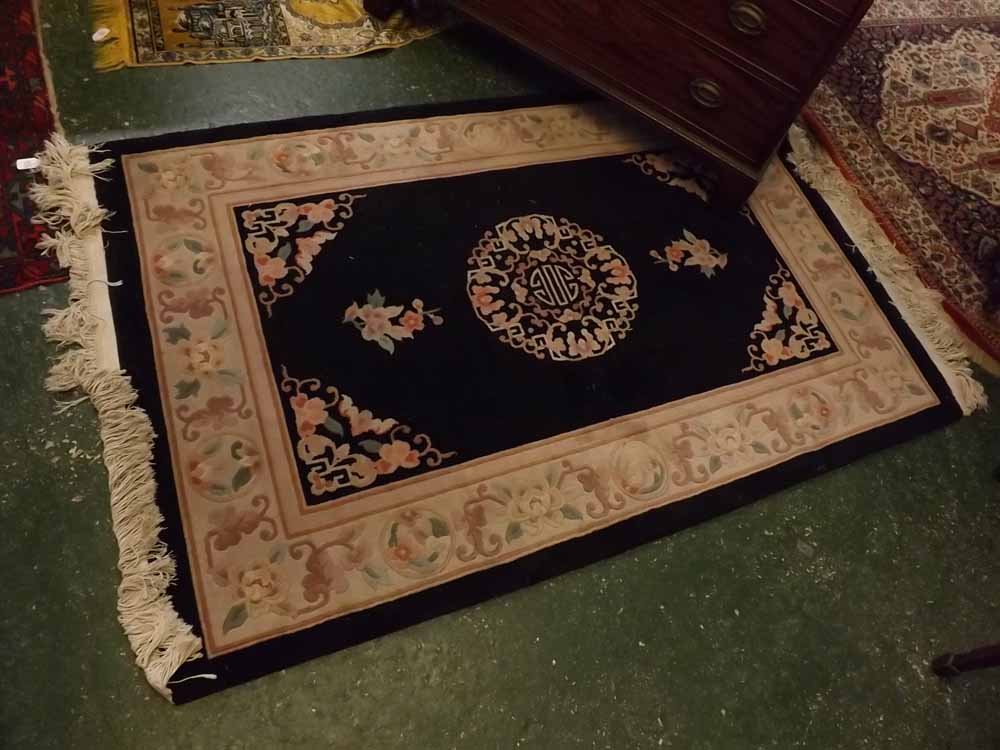 Small Chinese wool rug, floral border on a black field, 48 x 73ins