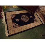 Small Chinese wool rug, floral border on a black field, 48 x 73ins