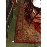 English Caucasian style carpet, floral panels on a mainly red field, 9ft x 10ft 6ins