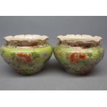 Pair of squat jardinires with a gilt and floral design on a green background with a fluted top (a/f)