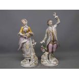 Pair of Sitzendorf figures of a dandy and his female companion, 9ins high
