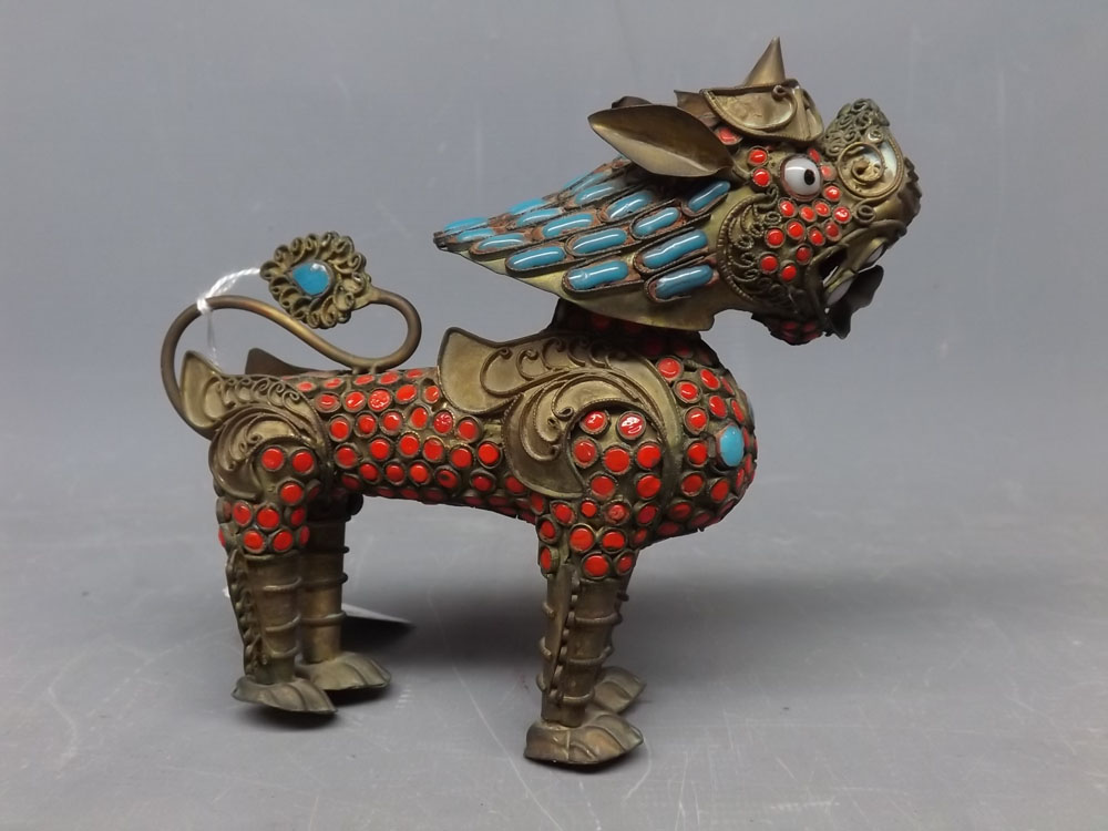Gilt metal and garnet stone applied model of an Oriental dragon, 5 1/2 ins long
