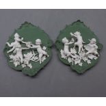 Pair of German oval green basalt putti mounted wall plaques with raised detail (a/f), 11ins wide x