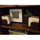 Art Deco period marble clock garniture, crested with a spelter butterfly and comprising a clock with