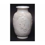 Chinese blanc de chine moulded vase with panels of equestrian figures within a diaper ground and