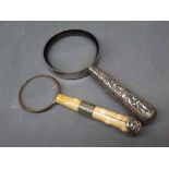 Two magnifying glasses, one with a white metal Indian style handle, the other with an ivory