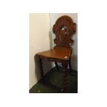 Victorian oak hall chair with carved and open back raised on bobbin turned legs