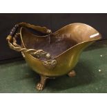 Brass coal helmet with decorative wyvern entwined handle, with a turned treen centre on a three-